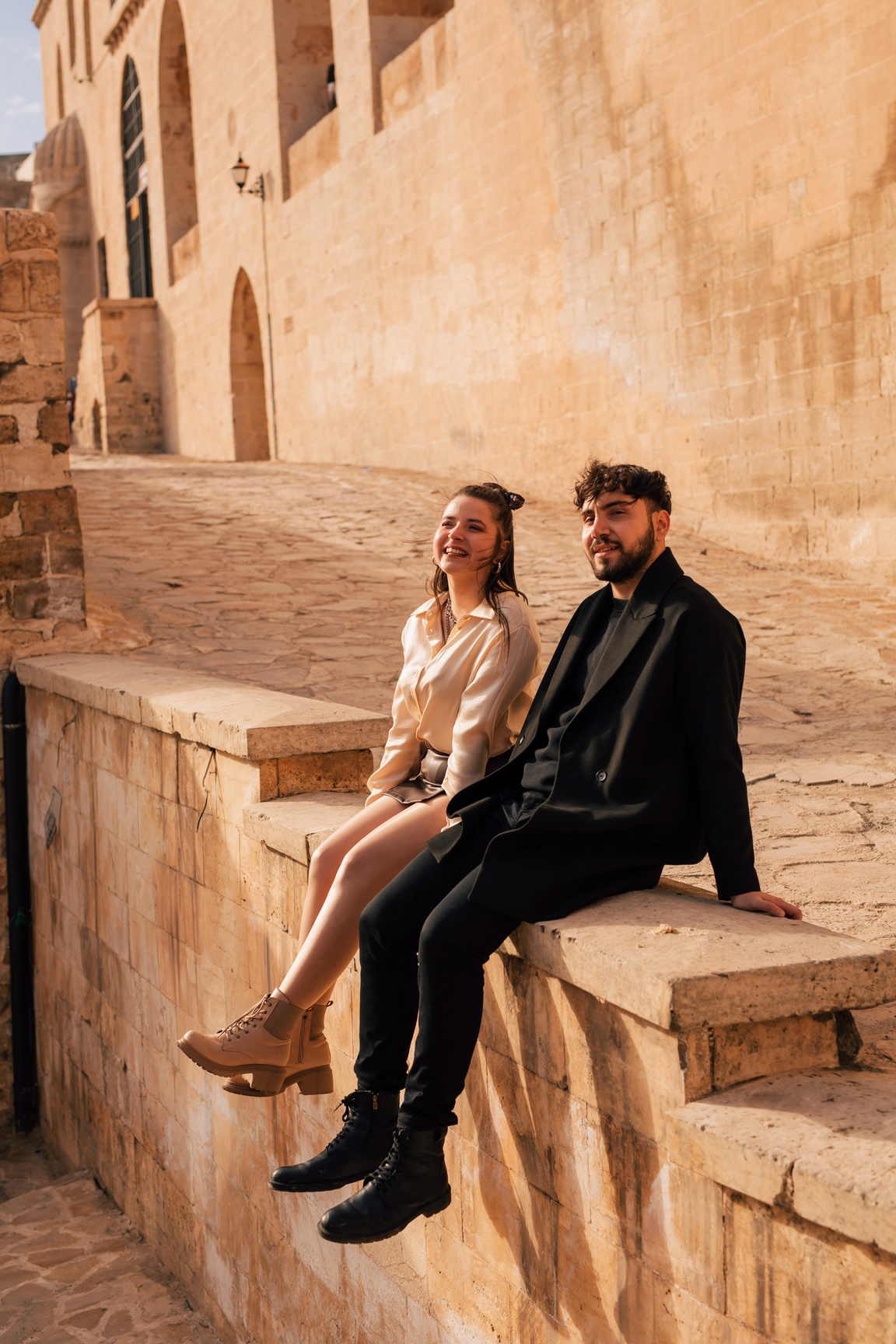 Male and Female Tourists Sitting by the Road